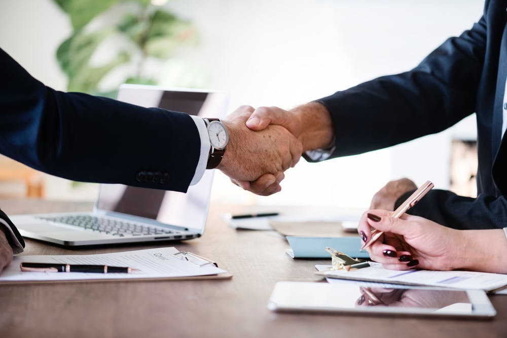 Two men shaking hands over a deal